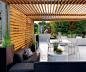 A cedar slat canopy over the terrace atop the garage offers privacy and shade.: 