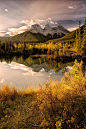 Three Sisters reflected in the lake near Canmore, Alberta, Canada