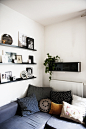 Thin black shelving on the wall