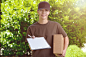 Smiling female courier delivering a parcel by Lars Zahner on 500px