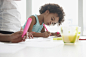 Black sisters drawing at breakfast table by Gable Denims