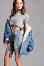 Cutout Denim Bermuda Shorts :   A pair of denim Bermuda shorts featuring a cutout at the knee, distressed design, zipper fly, five-pocket construction, and a frayed hem. This is an independent brand and not a Forever 21 branded item. 