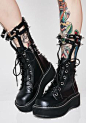 Demonia Devil In Disguise Caged Boots cuz you've got trix up ur sleeves. Get your goth princess on in these platform boots that have a dope strappy ankle design with sikk studz to keep ‘em away.