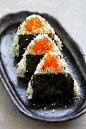 Easy and quick Japanese rice balls snacks shaped in triangles and wrapped with seaweeds.