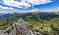 A mountaintop view on a small lake and wooded mountains in Triglav National Park