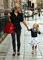 Alex Curran Gerrard (with one of her adorable daughters) in black skinny jeans, black Alexander McQueen shirt, and black Miu Miu flats, accessorized with bright red Fendi bag.: 