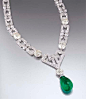 Art deco emerald and diamond necklace by Chaumet. Designed as graduated openwork rectangular links with two-stone spacers set with four cushion-shaped diamond collets, the central openwork plaque suspending a circular-cut diamond and drop-shaped emerald p