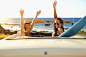 Women cheering in convertible on beach by Gable Denims on 500px
