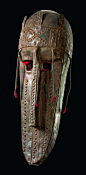Africa | Mask from the Marka/Marka Soninke people of Mali | Wood, punched metal sheet, five projections with red fringes in the area of nose and temples | all along the Niger this mask type is used for ceremonies associated with fishing and agriculture.