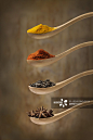 Herb and spices in wooden spoon on rustic wooden background.