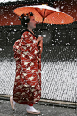 Geisha (Japanese traditional dancers) walk in the snow at Gion on January 7, 2006 in Kyoto, Japan.