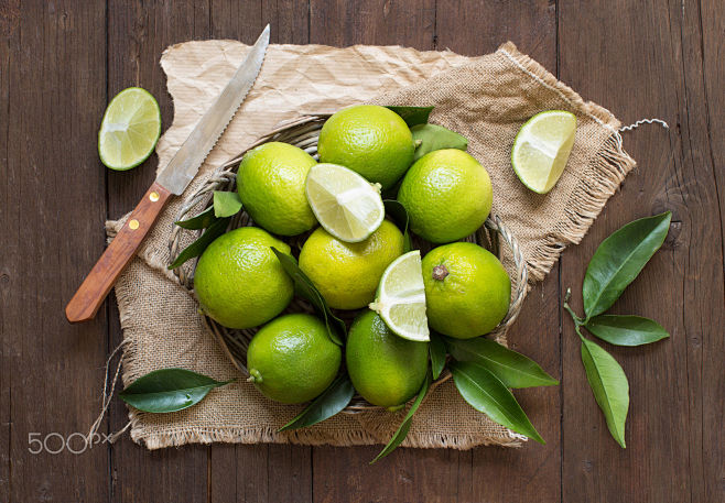 Fresh limes with kni...
