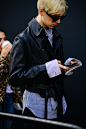 Boy wearing a black leather jacket