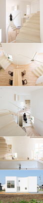日本建筑师Yukiko Nadamoto为四口之家设计的白色木结构住宅，位于岩手县北上市。室内独特的楼梯设计是亮点。