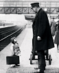 Which platform? A very young passenger asked a station attendant for directions, on the railway platform at Bristol, England, 1936. Photo by George W. Hales.: 