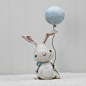 Lilly - Paperclay bunny Is hand sculpted from paper clay. Painted in acrylics, watercolor and sealed with matte varnish. Lily's patch on her stomach is made from hand tinted paper and is embellished with a few stitches. The balloon string is made using bl
