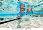 Underwater photo of a couple snorkeling in ocean and making selfie with stick