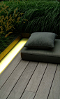 Wooden terrace with integrated lighting cove. Landscape design by Vitalis.