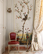 An 18th-century painted chinoiserie panel and gilded-bronze candelabra in the dining room.: 