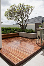 This looks as though it should be a roof terrace. This decked patio is by Tim Davies Landscaping: 