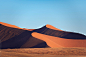 "Detail of a sand dune in Namib desert, with blue and clean sky, Africa" by Stocksy Contributor "Elena Saurius & Dani Rex"