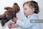 Toddler boy asleep holding a teddy bear