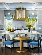 A Lewis chandelier and Leyden sconces from Hudson Valley Lighting brighten the Atlanta kitchen. The banquette — covered in Interlude from Thibaut's Portico collection of Sunbrella fabrics — offers cozy seating around a Grothouse walnut table with metalliz