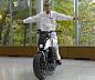 Honda Riding Assist Motorcycle : Honda's one-off Riding Assist motorcycle uses an advanced steering actuator to keep itself balanced at rest or at low speeds. Its front wheel and fork can also be adjusted to provide greater balance. As a bonus, it can mov