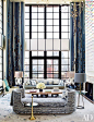 In the double-height living room, a Deniot-designed daybed covered in a Métaphores fabric and accented by an Hermès ...