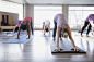 Women practicing downward facing dog in yoga class by Hero Images  on 500px