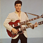 Portrait of American singer and actor Elvis Presley (1935 - 1977) as he holds a 12-string guitar, mid-1950s.