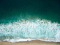 Drone aerial view of the waves washing on the Redondo sand beach