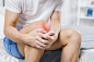 Close-up of a man holding sore knee Free Photo