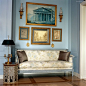 blue walls, settee and art in an apartment in NYC