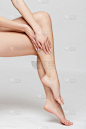 Long pretty woman legs, isolated on grey background