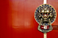 Asian Lion Door Knocker on Red Background