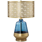 This striking cobalt blue and gold contemporary table lamp features a blue glass base and a cut-out metal drum shade.