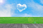 Picture of a heart cloud on blue sky in green field by Prasit Rodphan