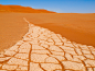 Cracked soil and red sand of Namib desert in Namibia by Petr Polak on 500px