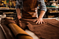 Close up of a cobbler working with leather textile Free Photo