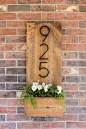 How to make a vertical house number sign for your home exterior, easily mountable right by a front door. Includes a little planter to add some pretty color.