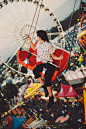 Fair swings with carnival in the background. Colored photography.