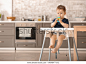 Cute little boy with nibbler in kitchen at home