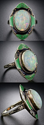 Art Deco Opal and Enamel Ring. A glowing opal of many colors is exotically presented in this intriguing antique Art Deco ring adorned with dramatic green and black enamel. This fabulous vintage jewel measures one inch long by 5/8 inch wide. Tres cool. Siz