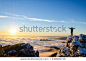 hiker celebrating success on top of a mountain in a majestic sunrise