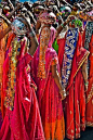 Girls carrying clay decorated pots...India