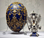 The “Tsarevich” Fabergé Egg: Presented by Nicholas to Alexandra in 1912. The lapis lazuli egg has gold cagework in a design including two Imperial double-headed eagles and floral garlands. The surprise is a Russian double-headed Imperial eagle with a mini