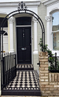 london victorian front garden company black and white chequer board mosaic yellow brick wall metal rail and gate rose arch: 