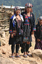 Akha tribal ladies in Laos. The Akha are an indigenous hill tribe who live in small villages at higher elevations in the mountains of Thailand, Burma, Laos, and Yunnan Province in China. They made their way from China into Southeast Asia during the early 