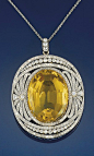 Circa 1905 diamond and citrine diamond pendant The oval citrine within a diamond openwork panel with palmette decoration and old-cut diamond collet detail, to a fine link chain.